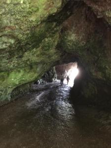 two people walking through a tunnel in a cave at Killoughagh House in Cushendall