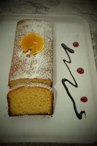 a white plate with a piece of cake with orange slices at Oasi di Villa Damecuta in Anacapri