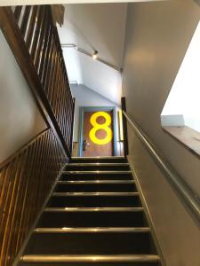 a stairway with a number eight sign on the wall at PubLove @ The Steam Engine,Waterloo in London