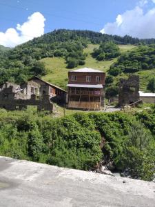 a house on the side of a hill at Raul Lushnu Darbaz in Mestia