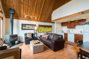 a living room with a couch and a stove at Vista View Chalet - 2 Bed 1 Bath Vacation home in Lake Wenatchee in Leavenworth