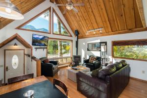 a living room with leather furniture and a vaulted ceiling at Vista View Chalet - 2 Bed 1 Bath Vacation home in Lake Wenatchee in Leavenworth