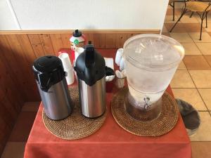 two coffee makers and a blender on a table at Wheels Motel in Greybull