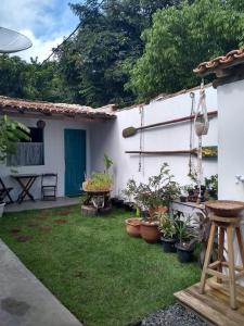 a garden in front of a white house with plants at Estação Caraíva in Caraíva