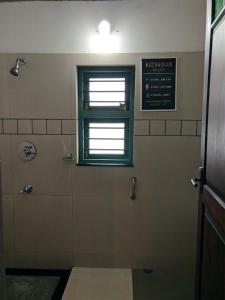 a bathroom with a shower and a window at ADRI CHEMBRA in Meppādi +30 photos