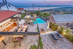 an overhead view of a house with a swimming pool at Villa LETA, luxurious 5 stars villa in a green oasis with fitness, heated pool, playground & barbecue, Kvarner in Hreljin
