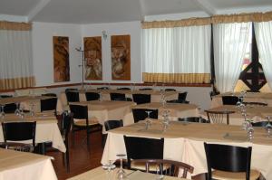 a dining room with tables and chairs with white tablecloths at B&B LATORRACA in Palazzo San Gervasio
