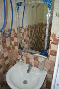 a bathroom with a sink and a mirror at hotel niks in Makhinjauri +48 photos