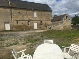 a group of chairs sitting in front of a building at Boutons d'or in Tierceville +2 photos