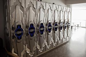 a row of blue vases on a wall at Puffin Nest Capsule Hostel in Vestmannaeyjar