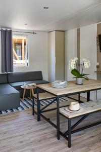 - un salon avec une table et un canapé dans l'établissement Rives d'Arc, à Vallon-Pont-dʼArc