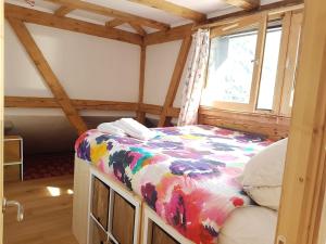 a small bed in a room with a window at Beautiful apartment in Chamonix centre with superb mountain views in Chamonix