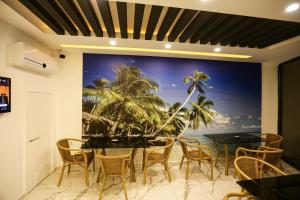 uma sala de jantar com um quadro de palmeiras em PAPİLLONADA HOTEL em Aidim