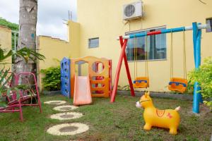 a playground with a toy dog in a yard at Condomínio Golden Goes in Porto Seguro