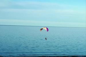 a person is kite surfing in the water at Alem in Puerto Madryn