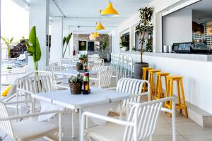 a row of white tables and chairs in a restaurant at Atlantic Holiday Hotel in Callao Salvaje