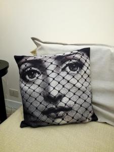 a black and white pillow with a face on it at Casa Elena in Ragusa