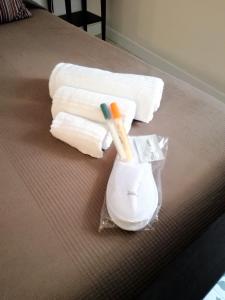 a toothbrush and towels are sitting on a bed at Casa Elena in Ragusa