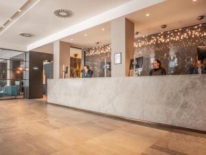 a lobby of a store with a reception counter at Apex City Of London Hotel in London