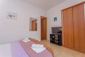 A bed or beds in a room at Apartments Milka