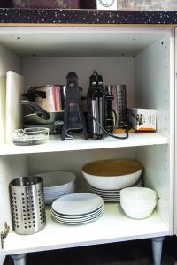 a shelf with plates and dishes on it at Catedral Reina Apartaments in Valencia