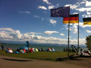 a group of tents on the grass next to the water at Ferienunterkunft Dolce Vita in Friedrichshafen +6 photos