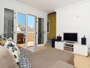 sala de estar con sofá y TV de pantalla plana en Centric Home - Solarium Terrace - Sea Views, en Arrecife