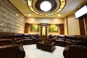 a waiting room with leather furniture and a circular ceiling at New Nairi Hotel in Yerevan