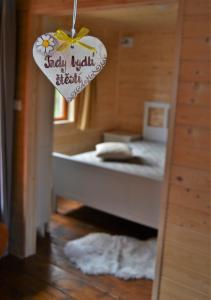 a bedroom with a bed with a heart sign on it at Nature Center Údolí volavek in Weseritz