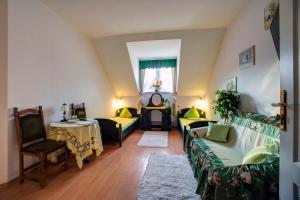 a living room with two couches and a table at Pensjonat U Bogusi in Berezka