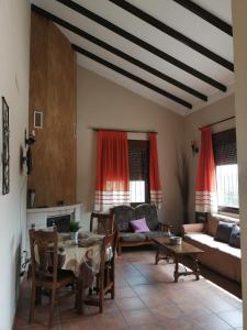 ein Wohnzimmer mit einem Tisch und einem Sofa in der Unterkunft La Solana de turón. La coscoja. in Ardales