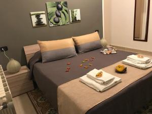 a bedroom with a bed with towels and food on it at BONORUM in Palermo