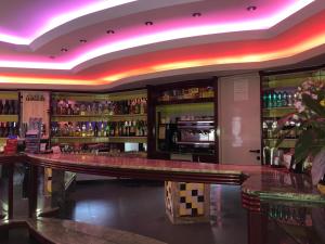 a bar in a restaurant with neon lights at B&B City Bar in Uta