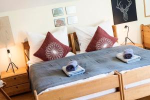 a bedroom with a bed with towels on it at Villa Anna Bad Goisern am Hallstättersee in Bad Goisern