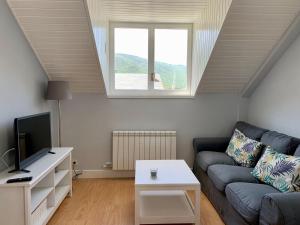 a living room with a couch and a window at BPIRINEOS-Blest in Benasque