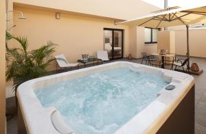 a jacuzzi tub in the middle of a living room at Eurostars Málaga in Málaga