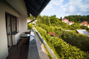 a balcony of a building with a table and chairs at Hotel Subcarpati in Curtea de Argeş