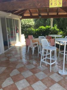 a patio with tables and chairs on a tiled floor at Apartments Iva in Orebić