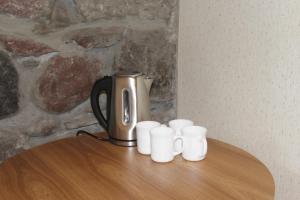 a coffee pot sitting on top of a table with cups at Rustaveli st11 in Kazbegi