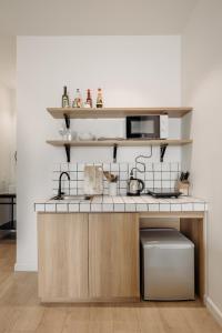 a kitchen with a counter with a microwave at Botanist Lab Minihotel by CIRCADIAN in Ho Chi Minh City