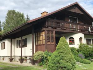 a house with a porch and a balcony at Pension Iva in Jeseník