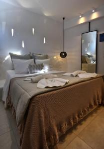 A bed or beds in a room at Quartano Luxury Cycladic Residence, Adults Only (13+)