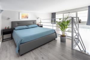 a bedroom with a bed with blue sheets and a ladder at Milky House Milan in Milan
