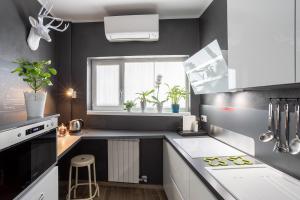 a small kitchen with white cabinets and a window at Milky House Milan in Milan