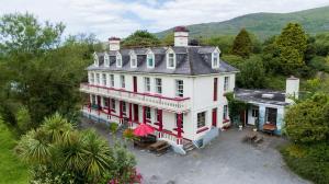 an aerial view of a large white house with red trim at Staigue Fort House in Caherdaniel