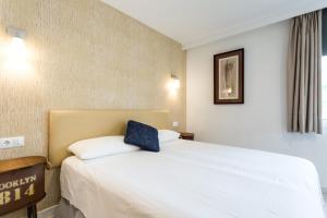 Кровать или кровати в номере Hotel Nómadas