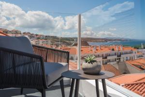 a plant sitting on a table on a balcony at Reserva FLH Hotels Ericeira in Ericeira
