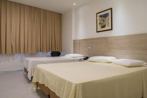 Ein Bett oder Betten in einem Zimmer der Unterkunft Hotel Rio Grande