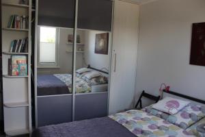 a bedroom with two beds and a glass closet at Apartament Nadmorski Zalewowa 12G in Sztutowo