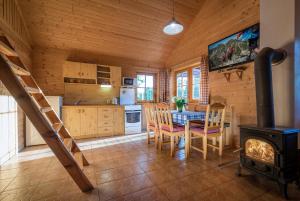 a kitchen with a table and a stove in a cabin at Montana Bobrovec in Bobrovec